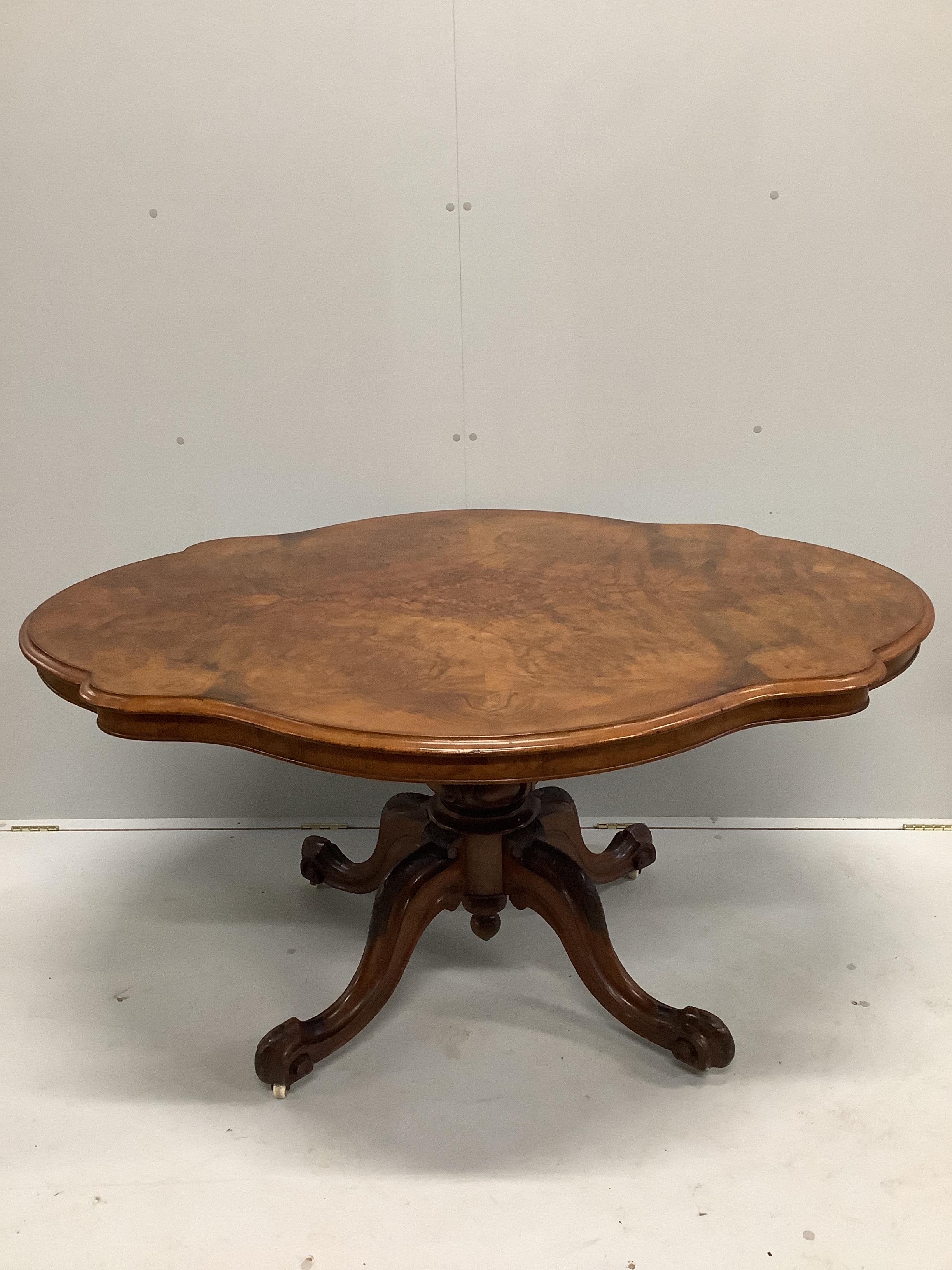 A Victorian burr walnut shaped oval tilt top loo table with quarter veneered top, width 146cm, depth 110cm, height 74cm